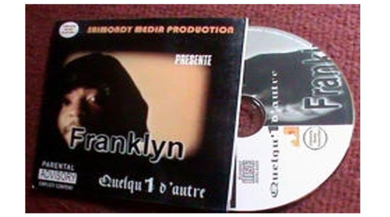 Une pochette de l'artiste Franklyn avec son Cd en dehors, sur la pochette. Titre de l'album et son nom en vue Quel(un d'autre